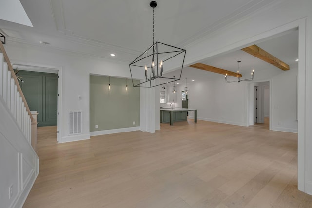 6060 Pasquo Rd, Nashville, TN 37221 - unfurnished living room featuring a chandelier, light wood-style floors, crown molding, beam ceiling, and stairway