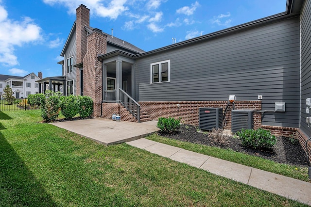 6060 Pasquo Rd, Nashville, TN 37221 - rear view of house with a patio area, a chimney, and brick siding