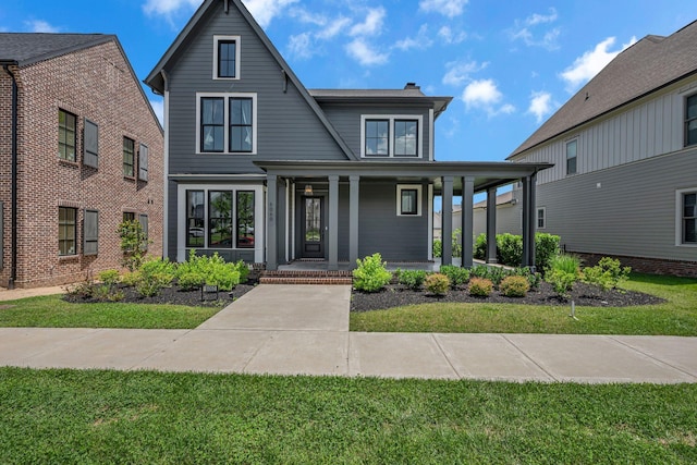 6060 Pasquo Rd, Nashville, TN 37221 - view of front facade featuring a porch, a chimney, and a front yard