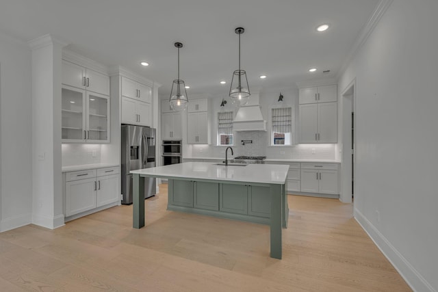 6060 Pasquo Rd, Nashville, TN 37221 - kitchen with stainless steel appliances, light countertops, decorative backsplash, white cabinetry, and light wood-type flooring