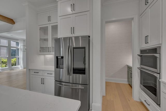 6060 Pasquo Rd, Nashville, TN 37221 - kitchen with appliances with stainless steel finishes, light wood-style floors, glass insert cabinets, white cabinetry, and crown molding
