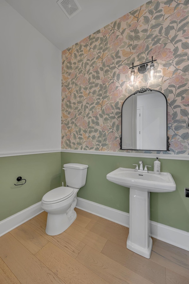 6060 Pasquo Rd, Nashville, TN 37221 - half bath featuring wallpapered walls, wainscoting, and wood finished floors