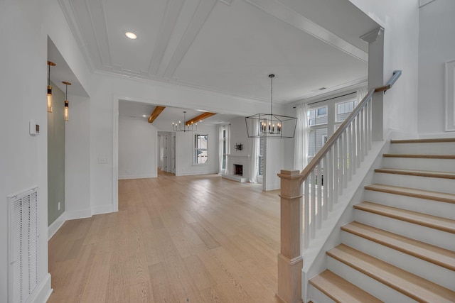 6060 Pasquo Rd, Nashville, TN 37221 - foyer featuring a chandelier, plenty of natural light, light wood-style flooring, stairs, and ornamental molding