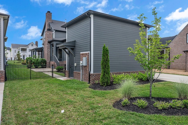 6060 Pasquo Rd, Nashville, TN 37221 - view of side of home with a chimney, brick siding, and driveway