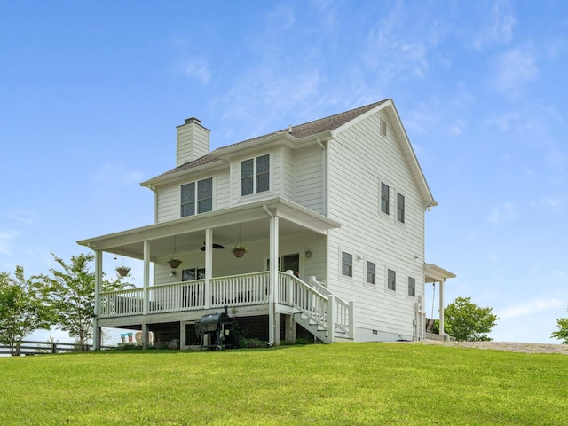 7811 Lampley Rd, Primm Springs, TN 38476 - rear view of property featuring a ceiling fan, a chimney, a yard, and stairway
