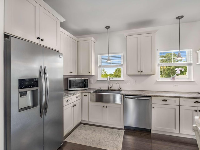 7811 Lampley Rd, Primm Springs, TN 38476 - kitchen with stainless steel appliances, healthy amount of natural light, light stone counters, and hanging light fixtures