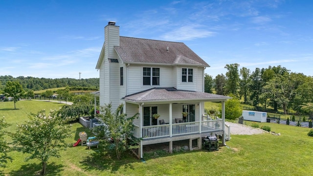7811 Lampley Rd, Primm Springs, TN 38476 - back of property featuring covered porch, roof with shingles, a chimney, and a wooded view