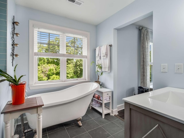 7811 Lampley Rd, Primm Springs, TN 38476 - full bathroom featuring a soaking tub, vanity, and tile patterned floors