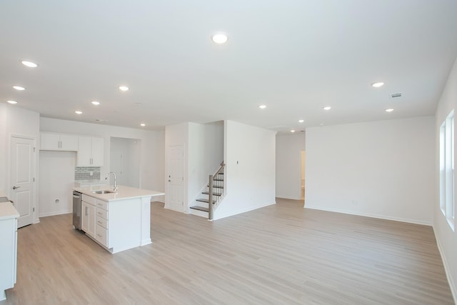 458 Jet Stream Dr, La Vergne, TN 37086 - kitchen featuring stainless steel dishwasher, light wood finished floors, light countertops, white cabinetry, and recessed lighting