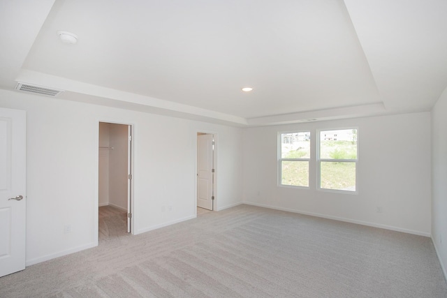 458 Jet Stream Dr, La Vergne, TN 37086 - unfurnished bedroom featuring a raised ceiling, a spacious closet, light carpet, and recessed lighting