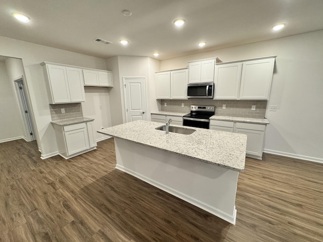 458 Jet Stream Dr, La Vergne, TN 37086 - kitchen with stainless steel appliances, a center island with sink, decorative backsplash, white cabinetry, and dark wood finished floors