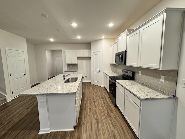 458 Jet Stream Dr, La Vergne, TN 37086 - kitchen featuring stainless steel appliances, dark wood-type flooring, tasteful backsplash, white cabinetry, and a kitchen island with sink