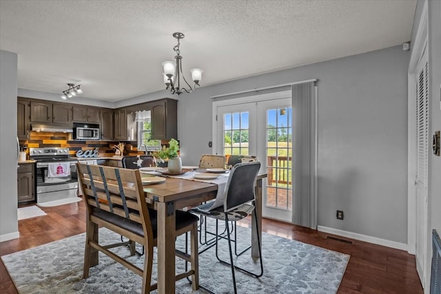 5455 Bales Rd, Cunningham, TN 37052 - dining room with a chandelier, a textured ceiling, dark wood-type flooring, and french doors