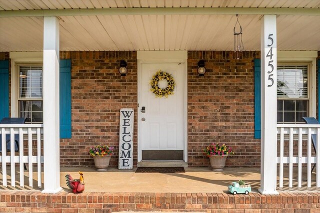 5455 Bales Rd, Cunningham, TN 37052 - view of exterior entry with a porch and brick siding