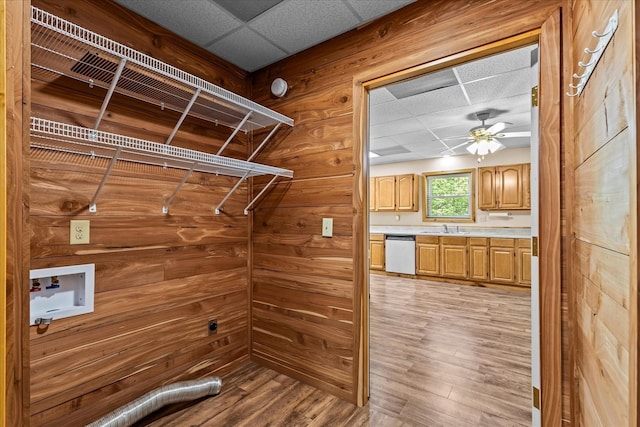 1697 Curtis Chapel Rd, Mc Ewen, TN 37101 - laundry room with a ceiling fan, hookup for a washing machine, light wood-style floors, wood walls, and cabinet space