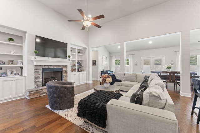 239 Mcclaran Pl, Murfreesboro, TN 37129 - living area featuring built in features, a ceiling fan, high vaulted ceiling, a stone fireplace, and wood finished floors