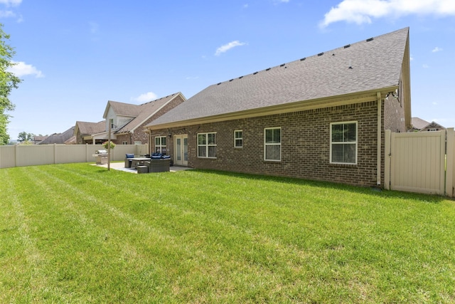 239 Mcclaran Pl, Murfreesboro, TN 37129 - back of property featuring a fenced backyard, brick siding, roof with shingles, and a patio