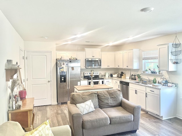 143 Belle Way, Athens, TN 37303 - kitchen with appliances with stainless steel finishes, white cabinetry, and light wood-style flooring