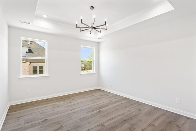 516 Little Penny Dr, Smyrna, TN 37167 - empty room with a raised ceiling, a chandelier, crown molding, wood finished floors, and recessed lighting