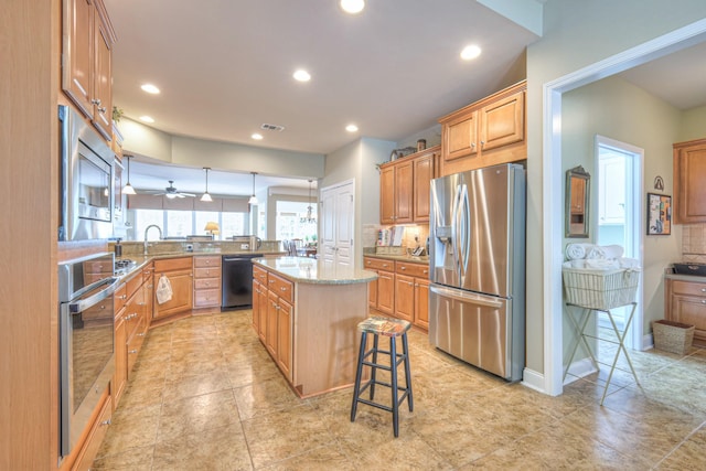 507 Bugler Rd, Mount Juliet, TN 37122 - kitchen with stainless steel appliances, a peninsula, decorative backsplash, recessed lighting, and a kitchen bar