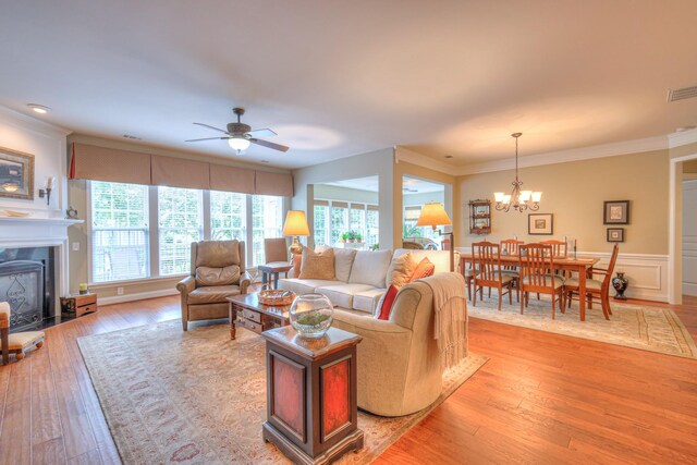507 Bugler Rd, Mount Juliet, TN 37122 - living area with a chandelier, a ceiling fan, ornamental molding, light wood-style flooring, and wainscoting