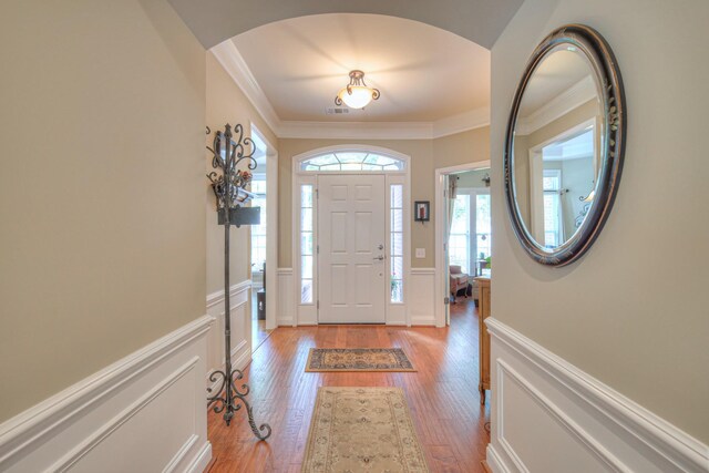 507 Bugler Rd, Mount Juliet, TN 37122 - entrance foyer featuring ornamental molding, light wood-style floors, a wainscoted wall, a decorative wall, and arched walkways