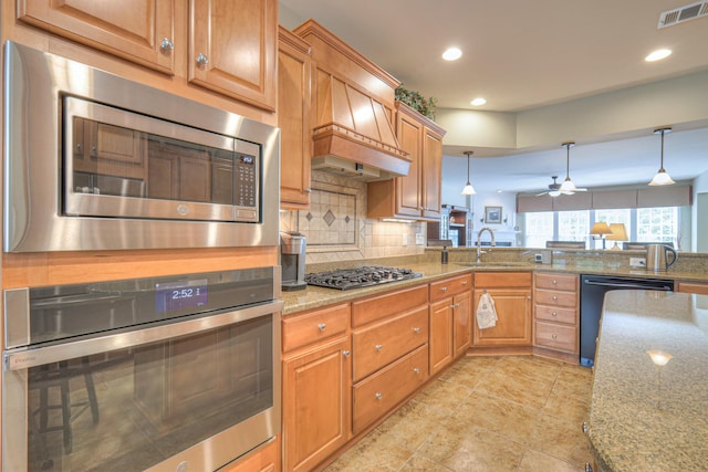 507 Bugler Rd, Mount Juliet, TN 37122 - kitchen with stainless steel appliances, tasteful backsplash, decorative light fixtures, light stone counters, and recessed lighting