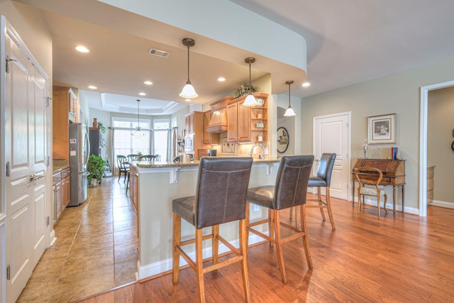 507 Bugler Rd, Mount Juliet, TN 37122 - kitchen featuring stainless steel appliances, open shelves, a raised ceiling, a breakfast bar, and recessed lighting