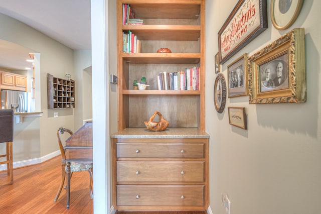 507 Bugler Rd, Mount Juliet, TN 37122 - detailed view of stainless steel refrigerator with ice dispenser, wood finished floors, and built in features