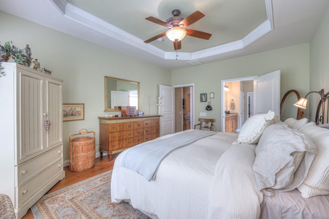 507 Bugler Rd, Mount Juliet, TN 37122 - bedroom with a tray ceiling, light wood-type flooring, ornamental molding, connected bathroom, and a ceiling fan