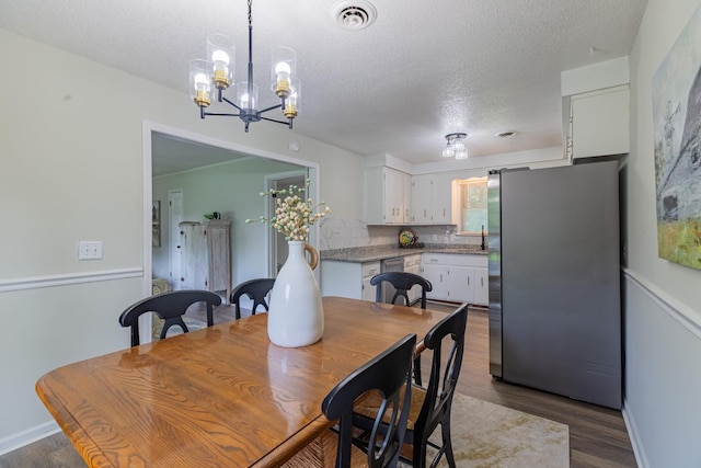 524 Inver Ln, Clarksville, TN 37042 - dining room with a textured ceiling, dark wood-style flooring, and a chandelier
