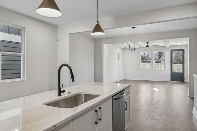 1734B Kellow St, Nashville, TN 37208 - kitchen featuring stainless steel dishwasher, decorative light fixtures, light stone counters, and white cabinetry
