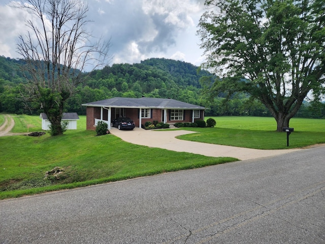 1036 Old Bottom Rd, Lafayette, TN 37083 - single story home with driveway, a view of trees, a front yard, a carport, and brick siding