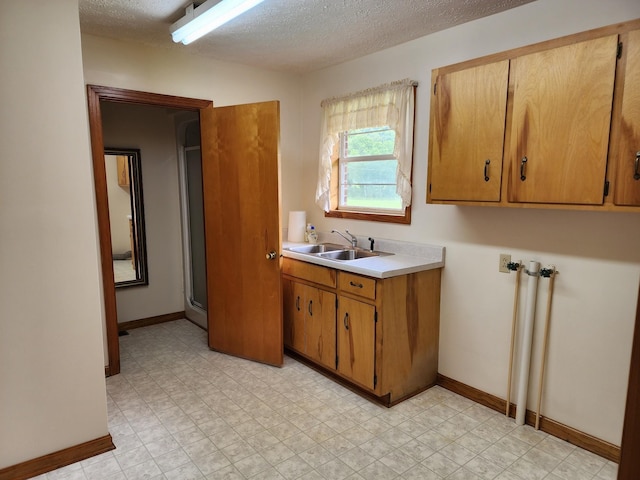 1036 Old Bottom Rd, Lafayette, TN 37083 - laundry area featuring a textured ceiling, cabinet space, and light floors