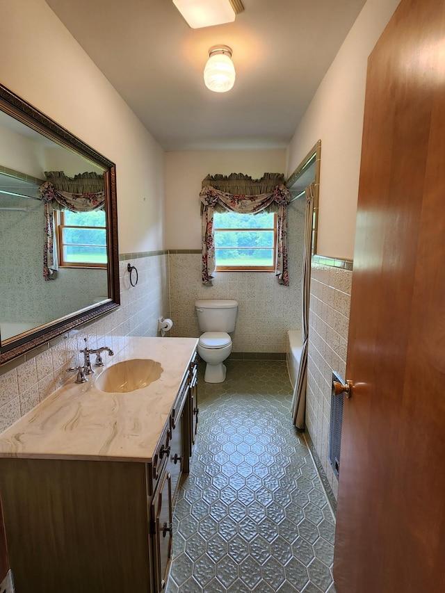 1036 Old Bottom Rd, Lafayette, TN 37083 - full bathroom with tile walls, a wainscoted wall, vanity, bathing tub / shower combination, and tile patterned floors