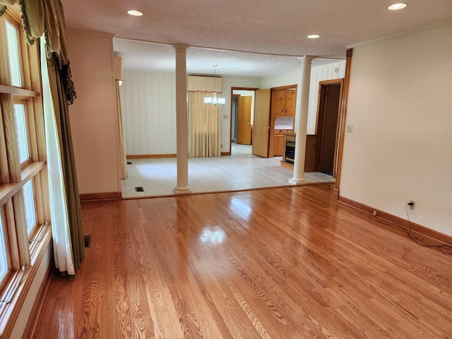 1036 Old Bottom Rd, Lafayette, TN 37083 - spare room with ornate columns, a chandelier, light wood-type flooring, and recessed lighting