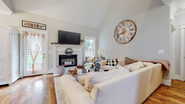 7146 Pepper Tree Cir, Fairview, TN 37062 - living area featuring light wood-type flooring, a fireplace, and high vaulted ceiling