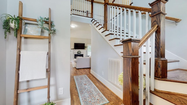 7146 Pepper Tree Cir, Fairview, TN 37062 - staircase featuring wood finished floors and a fireplace