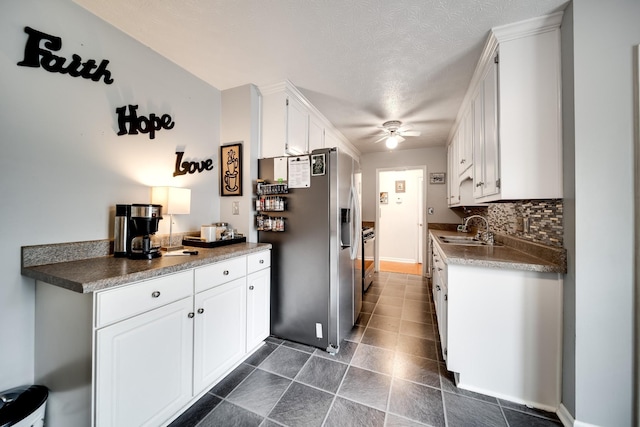 536 Deer Path, Gallatin, TN 37066 - kitchen featuring stainless steel fridge, ceiling fan, white cabinetry, tasteful backsplash, and dark tile patterned flooring