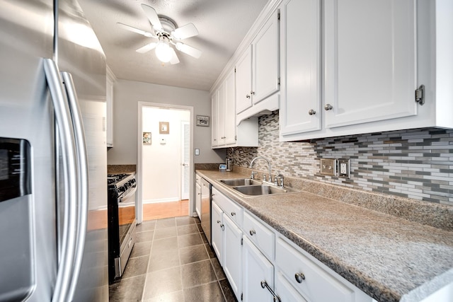 536 Deer Path, Gallatin, TN 37066 - kitchen featuring appliances with stainless steel finishes, ceiling fan, decorative backsplash, and white cabinetry
