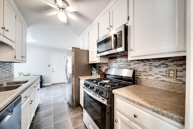 536 Deer Path, Gallatin, TN 37066 - kitchen with stainless steel appliances, white cabinets, a ceiling fan, and decorative backsplash