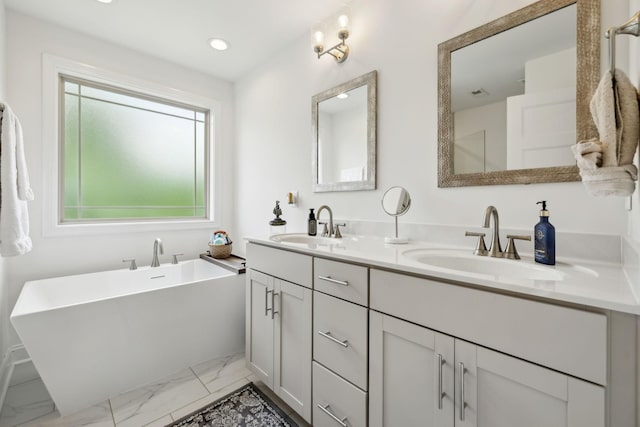 2968 Kirkwood Rd, Clarksville, TN 37043 - full bath with marble look tile flooring, double vanity, a freestanding tub, and recessed lighting