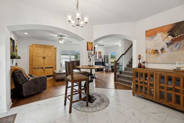 2968 Kirkwood Rd, Clarksville, TN 37043 - dining area with a ceiling fan, arched walkways, light marble finish flooring, stairs, and recessed lighting