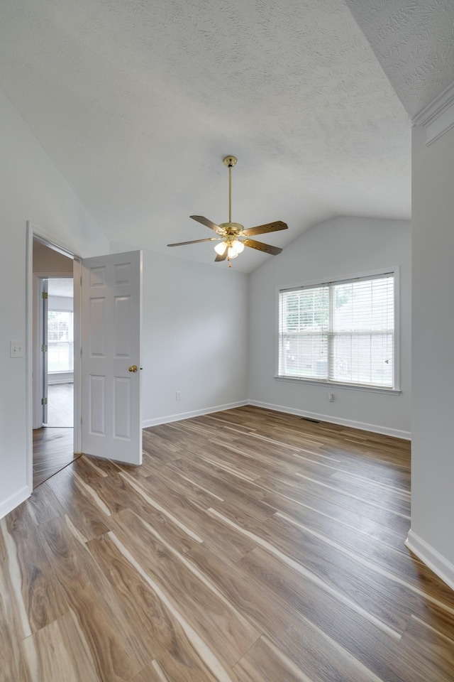 3216 Vestry Ave, Murfreesboro, TN 37129 - unfurnished room with vaulted ceiling, plenty of natural light, wood finished floors, ceiling fan, and a textured ceiling