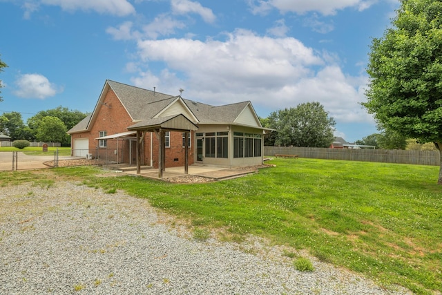 3216 Vestry Ave, Murfreesboro, TN 37129 - back of house featuring a sunroom, a patio, a shingled roof, brick siding, and a garage