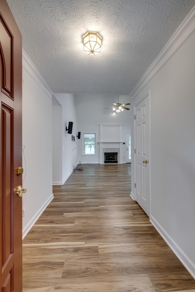 3216 Vestry Ave, Murfreesboro, TN 37129 - foyer featuring a ceiling fan, a textured ceiling, light wood-style flooring, crown molding, and a fireplace