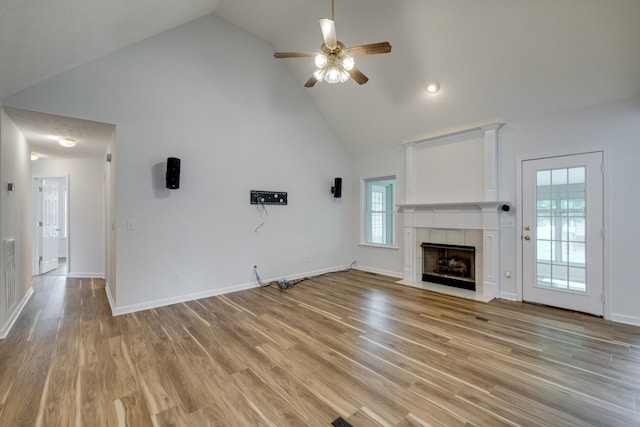 3216 Vestry Ave, Murfreesboro, TN 37129 - unfurnished living room featuring high vaulted ceiling, a ceiling fan, a tile fireplace, and light wood-style flooring