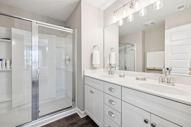 2515 Napa Valley Way, Columbia, TN 38401 - bathroom featuring double vanity, a stall shower, and wood finished floors