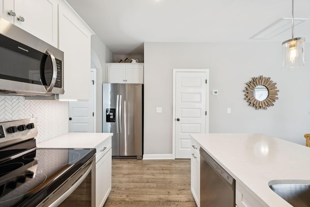 2515 Napa Valley Way, Columbia, TN 38401 - kitchen with appliances with stainless steel finishes, light wood-style flooring, tasteful backsplash, white cabinetry, and light countertops
