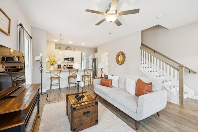 2515 Napa Valley Way, Columbia, TN 38401 - living area with light wood-type flooring, a ceiling fan, stairway, arched walkways, and recessed lighting